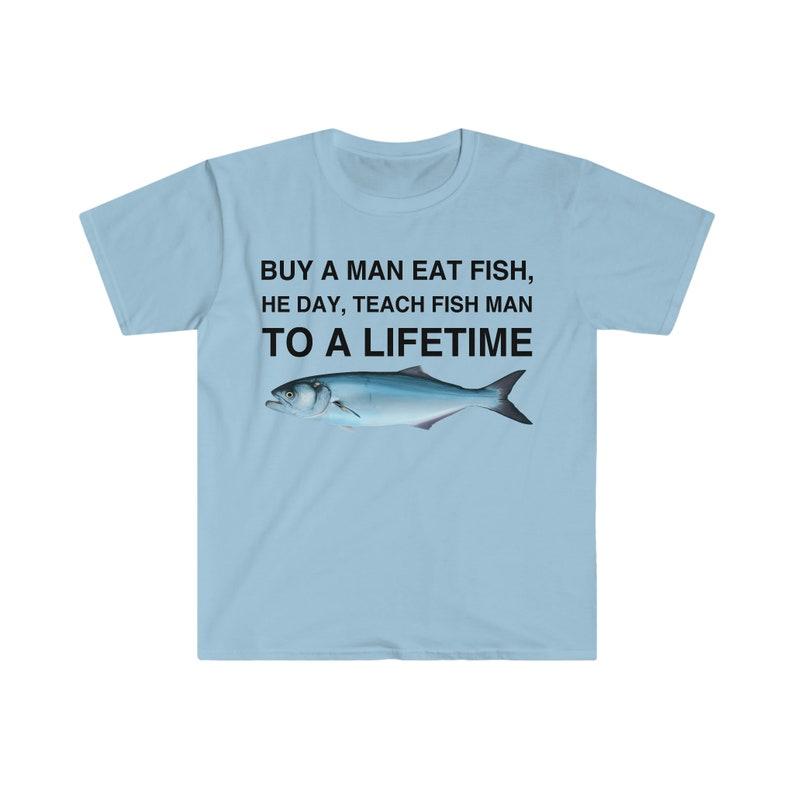 Buy a Man Eat Fish T-Shirt, He Day Teach Fish Man, Lively Meme T-Shirt for Humor Lovers, Unisex Casual Wardrobe Statement Piece