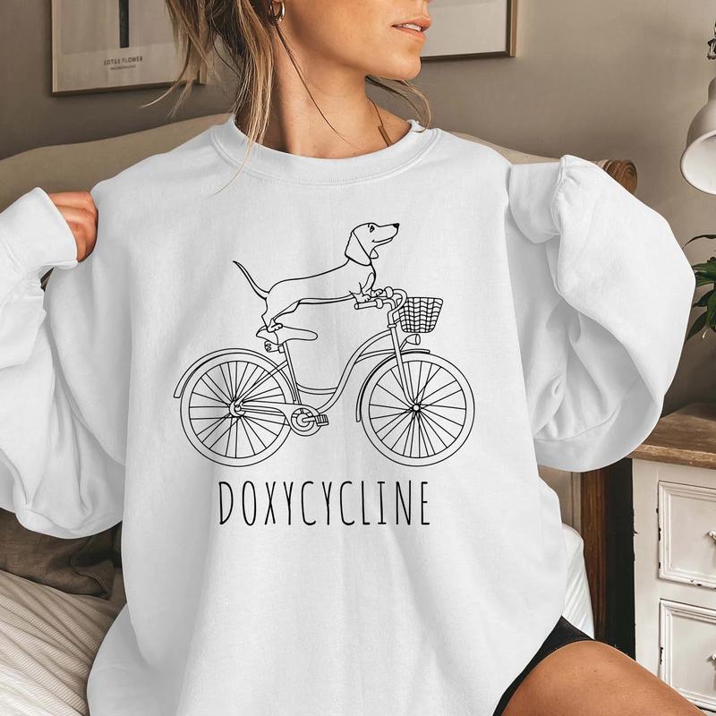Doxycycline Pharmacy Pun T-shirt - Pharmacists Sweatshirt, Dachshund on Bicycle, Perfect Gift for Pharmacists & Technicians sweatshirts