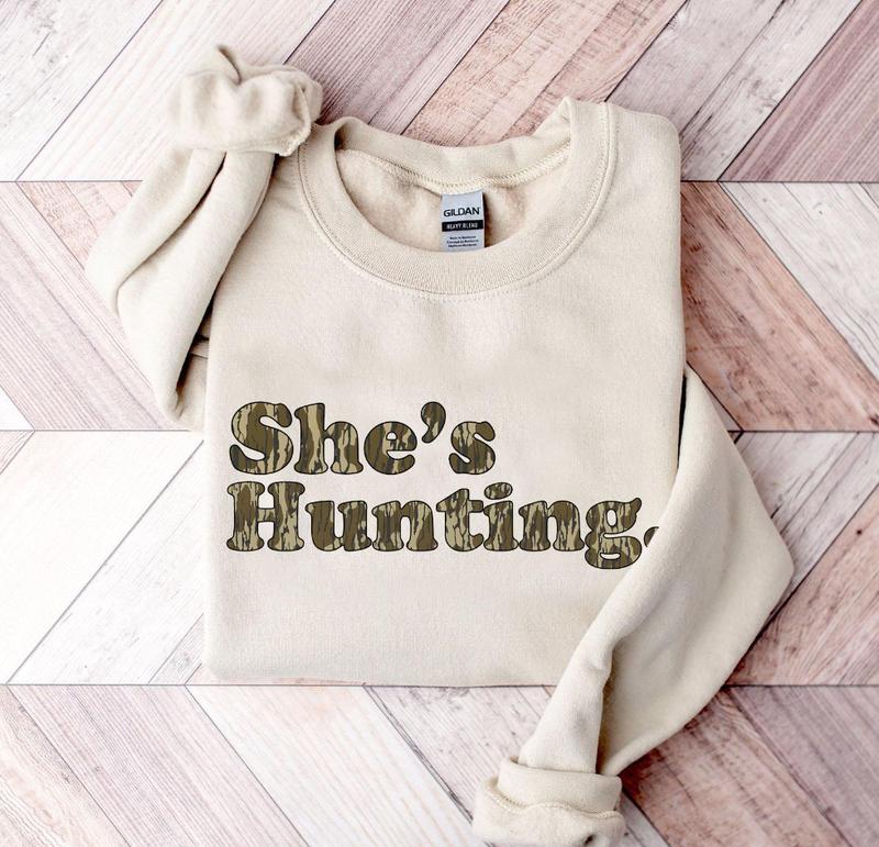 She is Hunting Camoflauge Bottomland Pattern Unisex T-shirt, Hunting Camo Graphic Printed Crewneck Sweatshirt, Unisex Mom Shirt Gift For Women